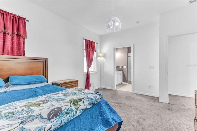 carpeted bedroom featuring ensuite bathroom