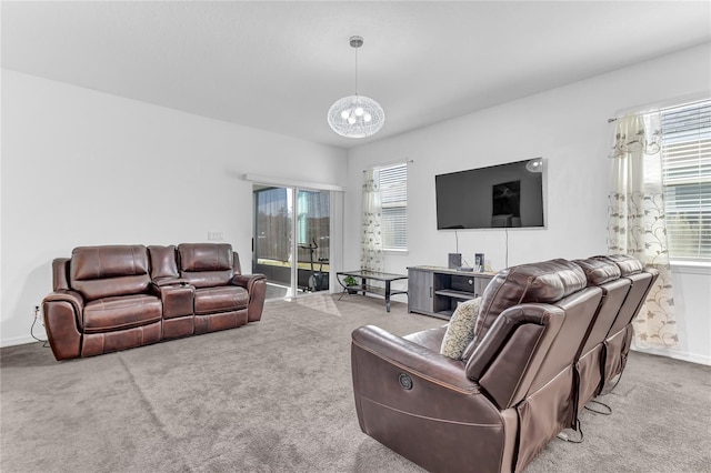 living room with light colored carpet and a chandelier