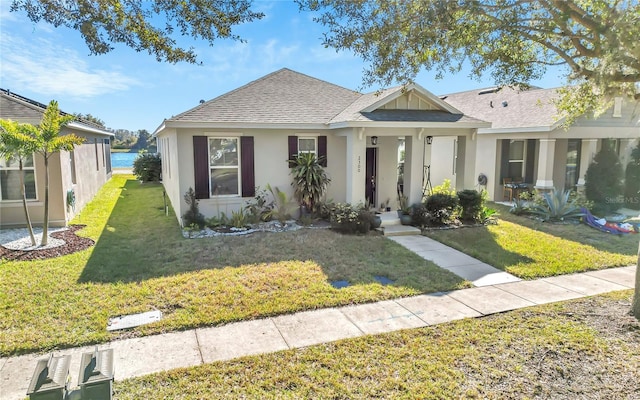 bungalow-style house with a water view and a front yard