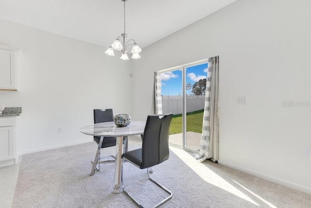 dining room with an inviting chandelier and light colored carpet