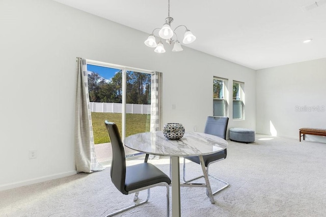 dining room featuring an inviting chandelier and carpet flooring