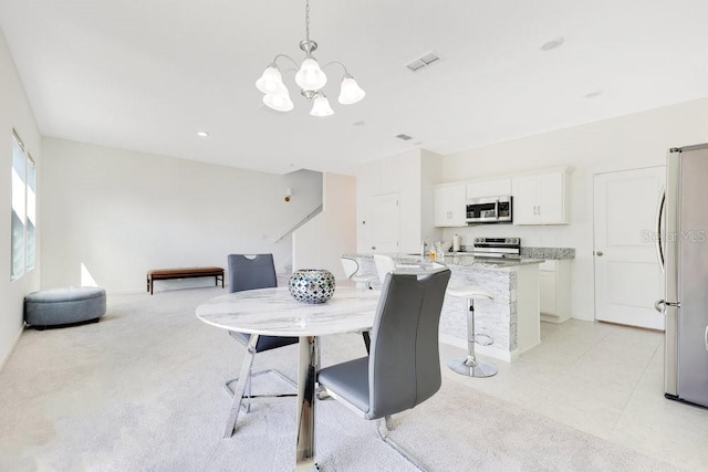 dining space featuring a notable chandelier