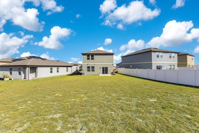 rear view of house featuring a yard