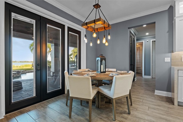 dining area featuring ornamental molding and french doors