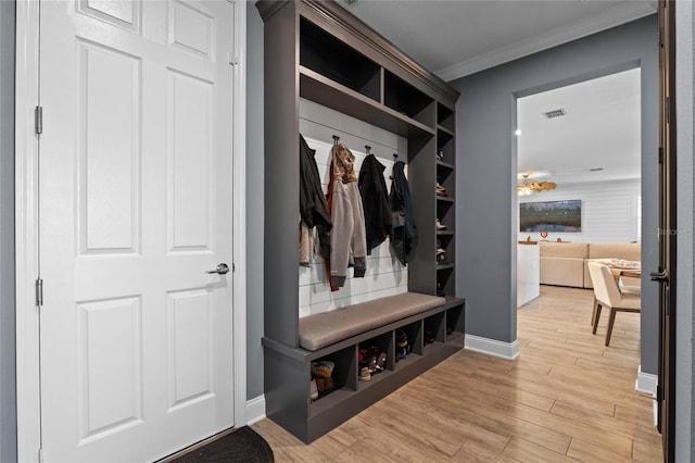 mudroom featuring crown molding and light wood-type flooring