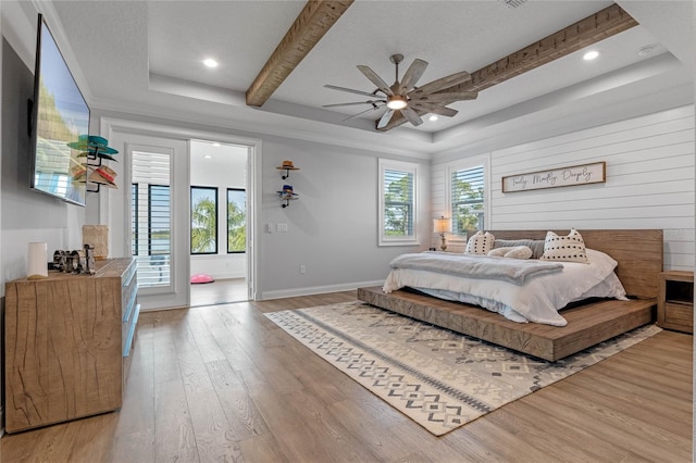 bedroom featuring multiple windows, light hardwood / wood-style flooring, and ceiling fan