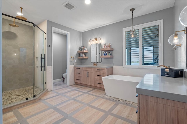 full bathroom with independent shower and bath, vanity, tile patterned floors, and toilet