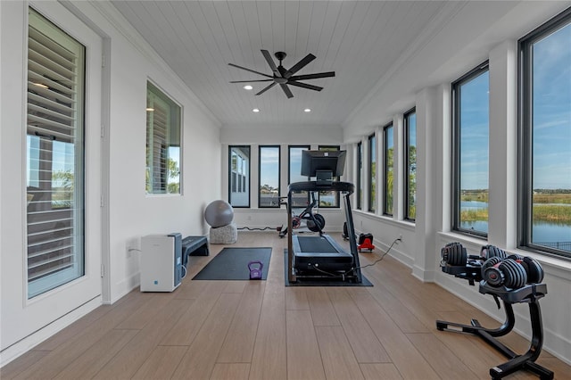 exercise room featuring wood ceiling, ceiling fan, ornamental molding, and light wood-type flooring