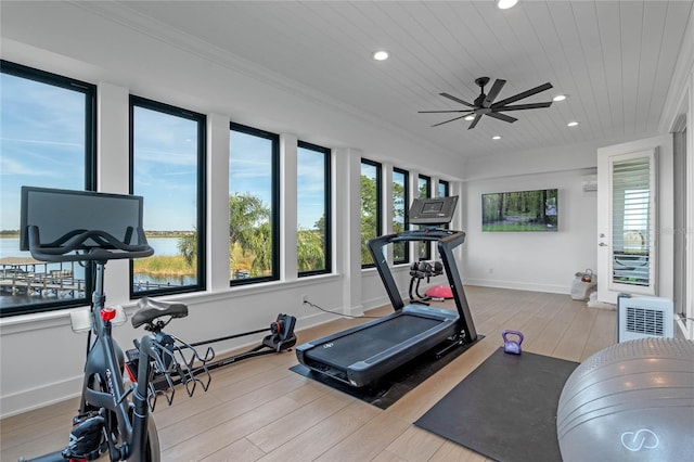 workout area with crown molding, wood ceiling, light hardwood / wood-style floors, and a healthy amount of sunlight