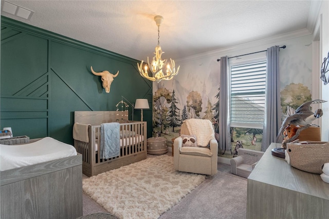 bedroom with crown molding, a nursery area, light carpet, and an inviting chandelier