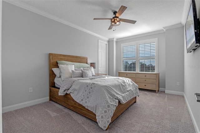 carpeted bedroom featuring ornamental molding, a textured ceiling, and ceiling fan