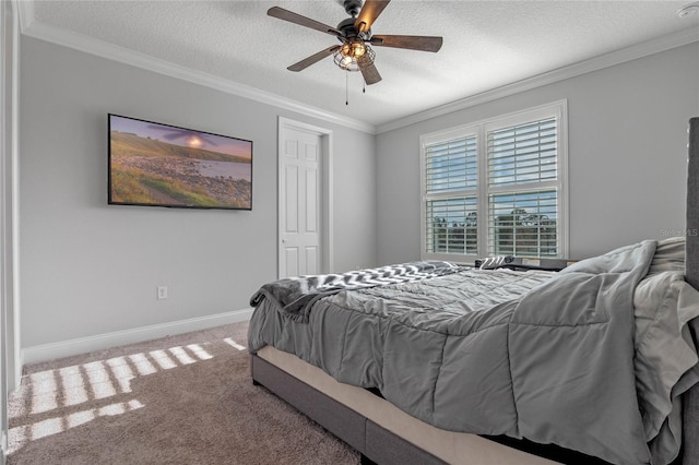 bedroom with ceiling fan, ornamental molding, carpet, and a textured ceiling