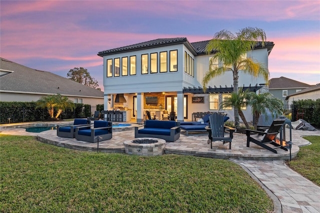 back house at dusk featuring a fenced in pool, a lawn, a pergola, a patio area, and an outdoor living space with a fire pit