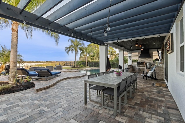 view of patio with area for grilling and a grill