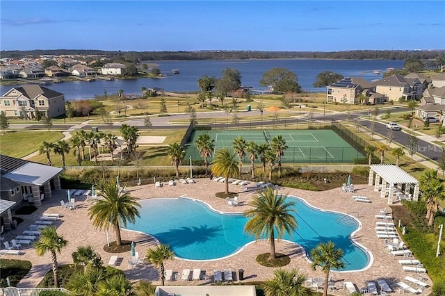 view of pool featuring a patio and a water view