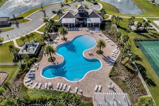 view of swimming pool featuring a water view and a patio