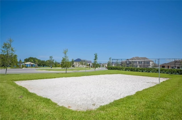 view of community featuring a yard and volleyball court