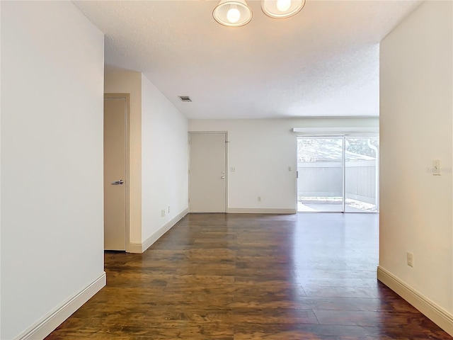 spare room with dark hardwood / wood-style flooring