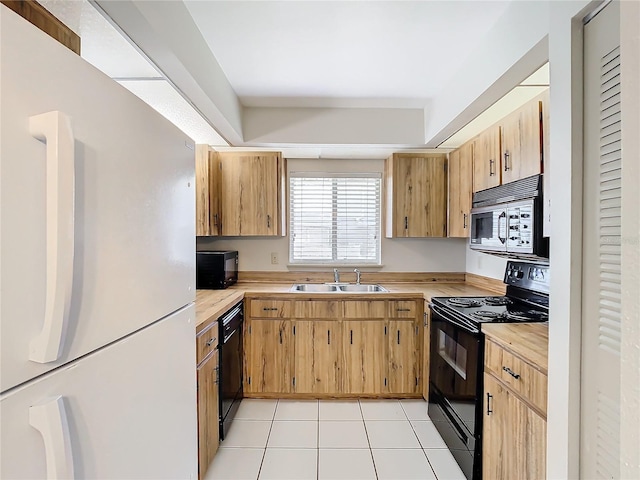 kitchen featuring light tile patterned floors, sink, and black appliances