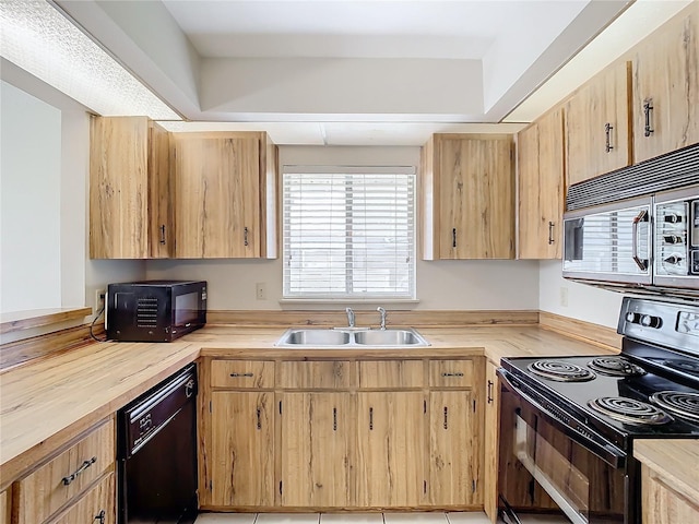 kitchen with sink, light brown cabinets, and black appliances