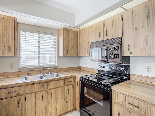 kitchen with sink, light brown cabinets, and black / electric stove