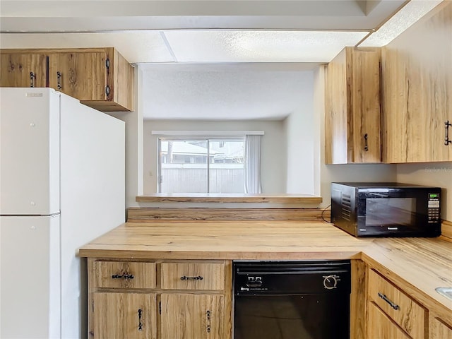 kitchen featuring butcher block counters and black appliances