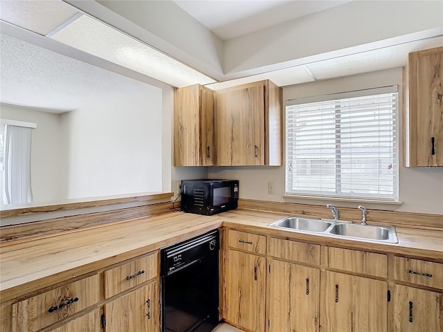 kitchen with sink, a textured ceiling, butcher block countertops, and black appliances