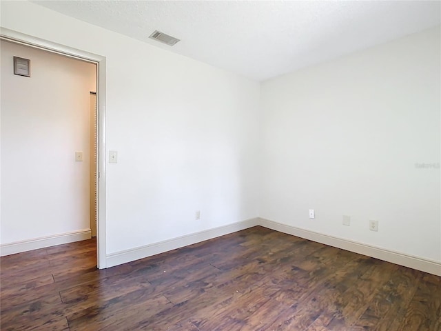 unfurnished room featuring dark hardwood / wood-style flooring