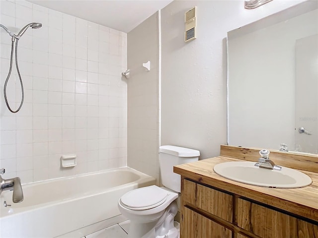 full bathroom with tiled shower / bath combo, vanity, and toilet