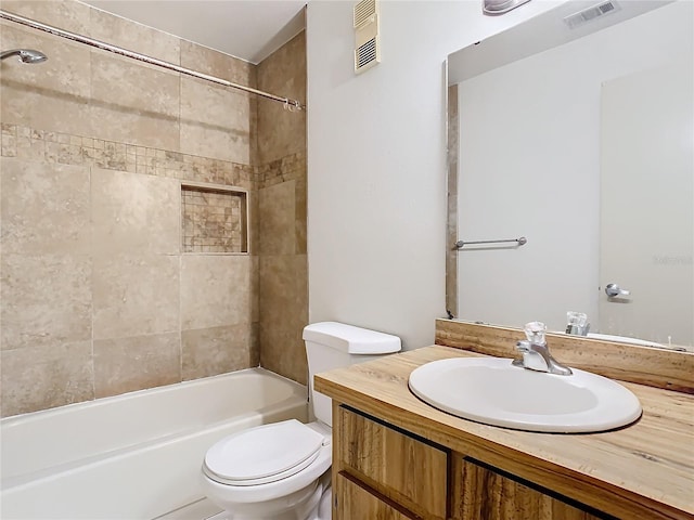 full bathroom with vanity, toilet, and tiled shower / bath combo