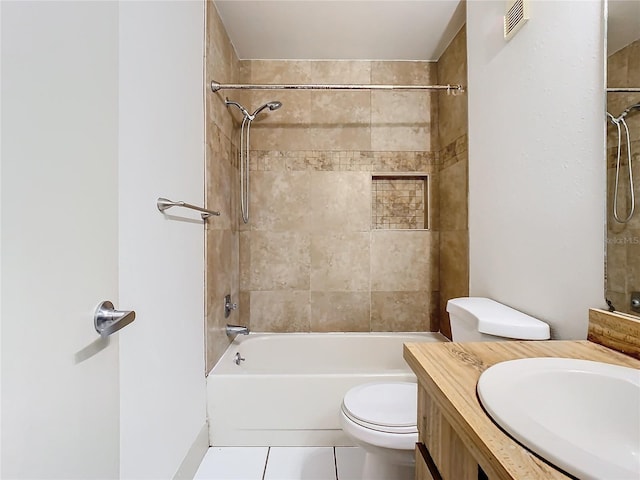 full bathroom featuring tile patterned floors, vanity, toilet, and tiled shower / bath combo