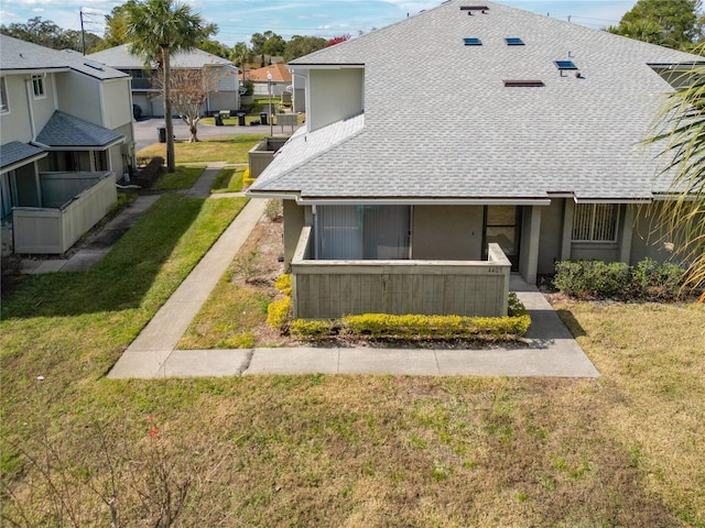 rear view of house with a lawn