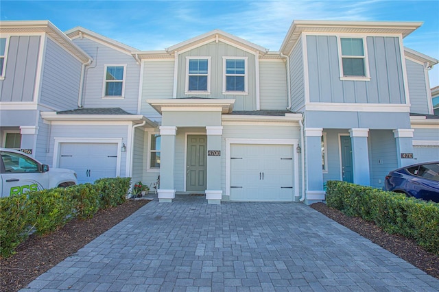 4708 Tribute Trl, Kissimmee, FL 34746 - townhome / multi-family property featuring decorative driveway, an attached garage, and board and batten siding