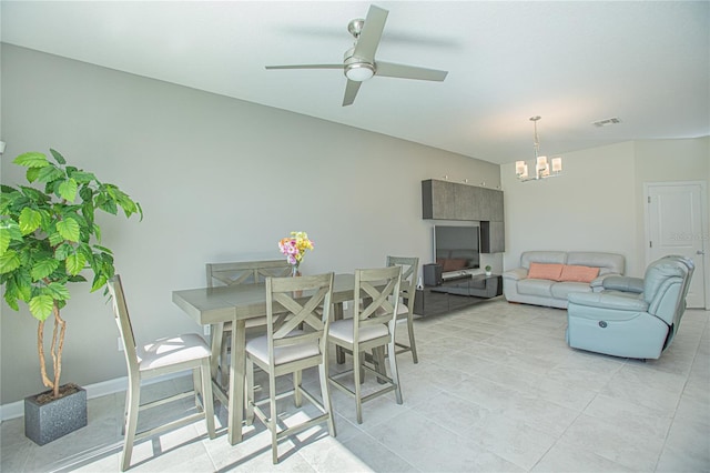 dining space featuring ceiling fan with notable chandelier