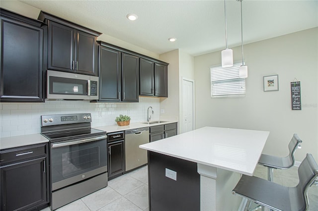 kitchen with stainless steel appliances, tasteful backsplash, a center island, and sink