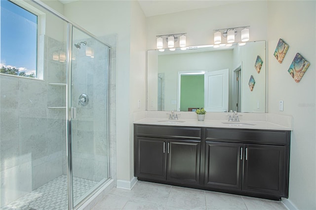 bathroom featuring a shower with door, vanity, and tile patterned flooring