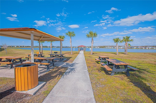 view of home's community featuring a water view, a gazebo, and a lawn