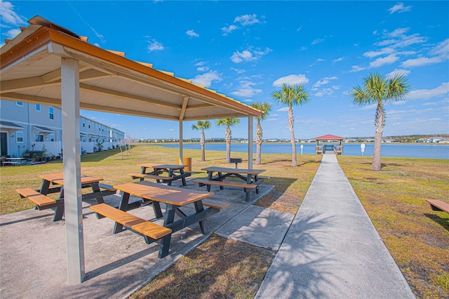 surrounding community with a gazebo, a water view, and a yard