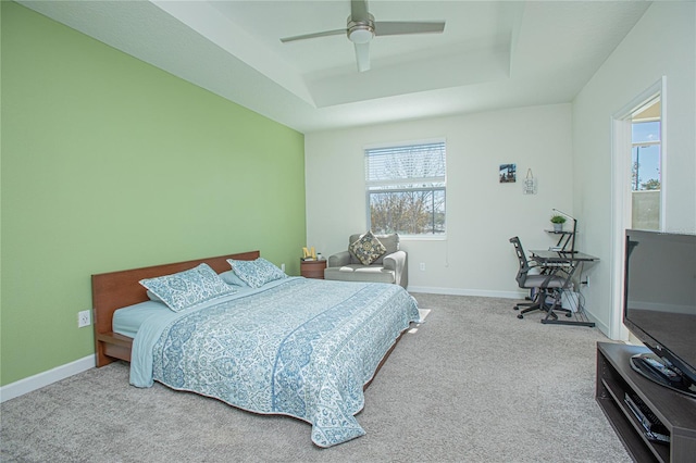 4708 Tribute Trl, Kissimmee, FL 34746 - carpeted bedroom featuring ceiling fan, a tray ceiling, and baseboards