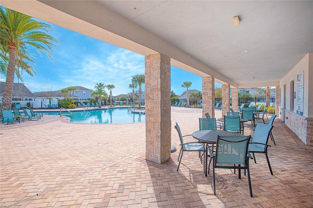 4708 Tribute Trl, Kissimmee, FL 34746 - community pool with fence and a patio area