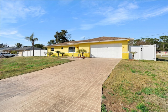 ranch-style home featuring a garage and a front yard