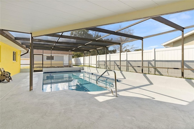 view of swimming pool featuring a lanai and a patio