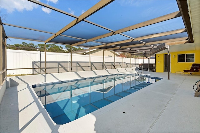 view of swimming pool featuring a lanai and a patio