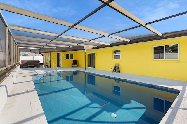 view of pool featuring a lanai, a patio area, and a hot tub