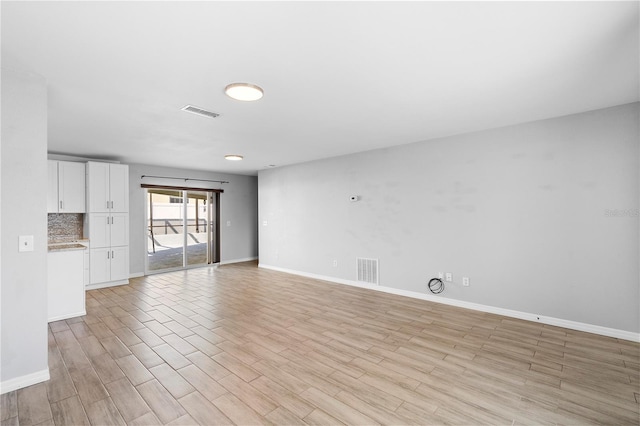 unfurnished living room featuring light hardwood / wood-style floors