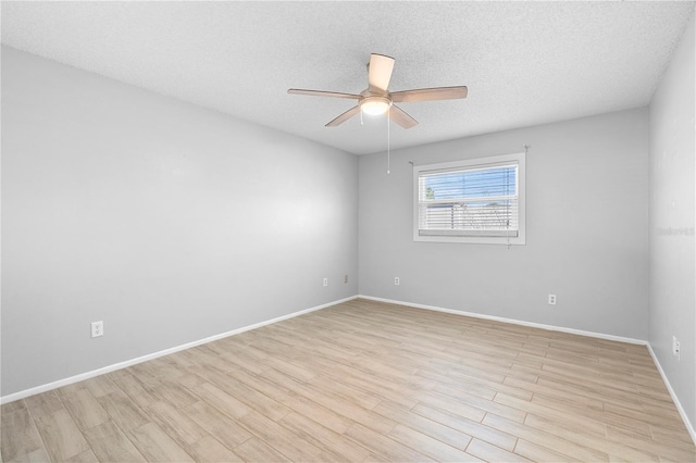 spare room with ceiling fan, light hardwood / wood-style flooring, and a textured ceiling