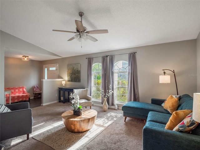 carpeted living room featuring lofted ceiling, ceiling fan, and a textured ceiling