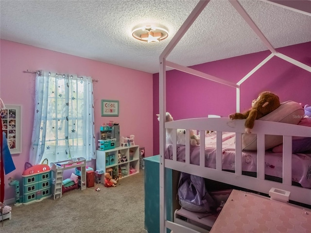 bedroom with a textured ceiling and carpet