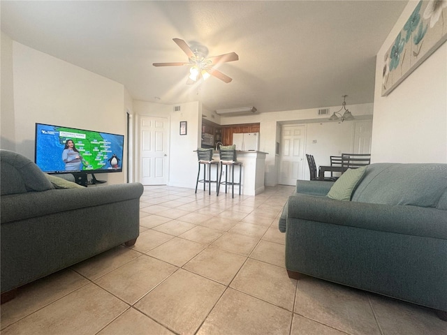 tiled living room with ceiling fan