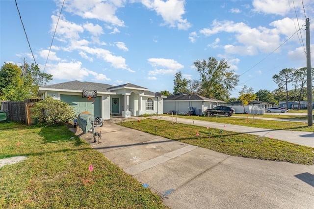 view of front of property with a garage and a front lawn